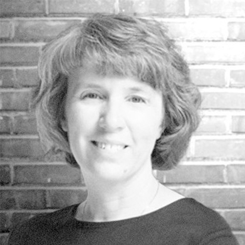 Headshot of Lawrence Livermore researcher Lori Diachin. Her headshot is in black and white. She smiles and stands in front of a brick wall. 