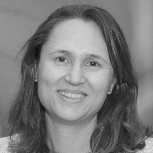 Headshot of National Energy Researcher Scientific Computing Center researcher Katie Antypas. Her headshot is in black and white. She smiles and stands in front of a blurred background.